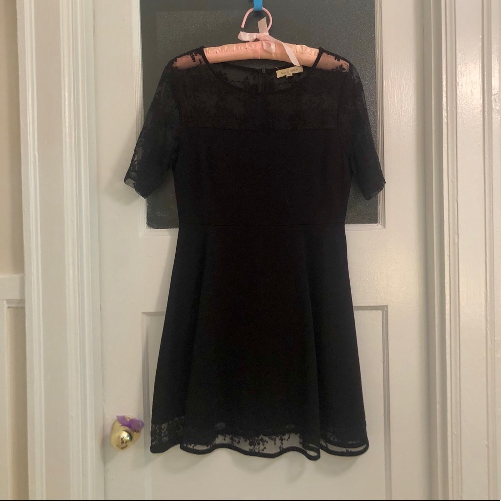 Black cocktail dress with lace cutouts